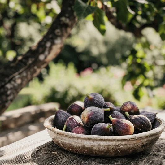 Bowl of Panache Tiger figs on a wooden surface with a blurred natural background
